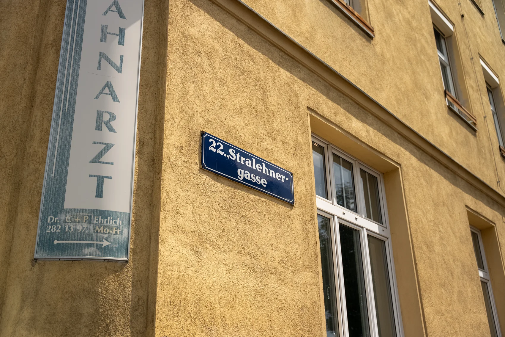 Street sign 22. Stralehnergasse on the yellow building facade