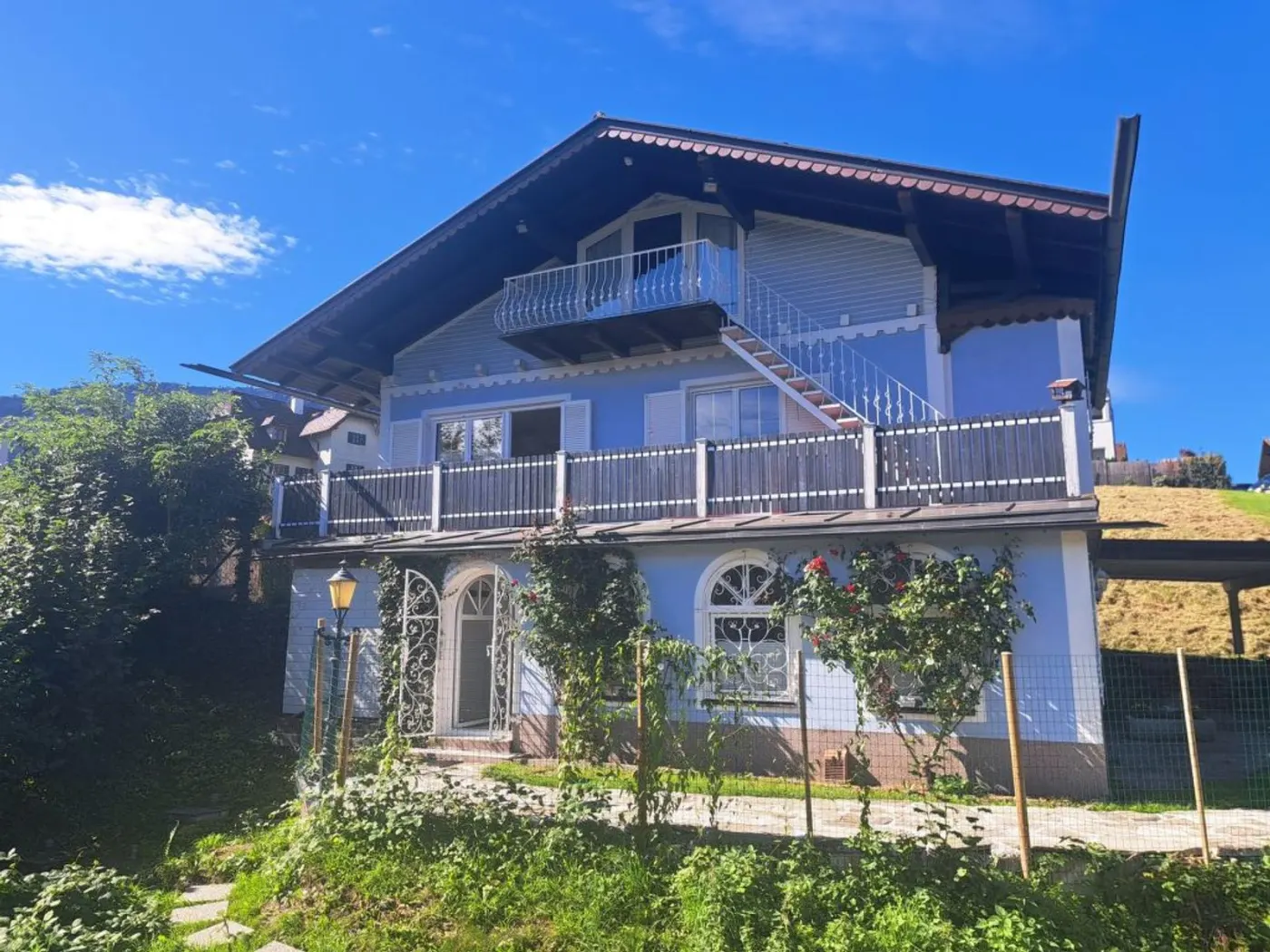 Garden side of Villa Rose with balcony, terrace and rose trellis
