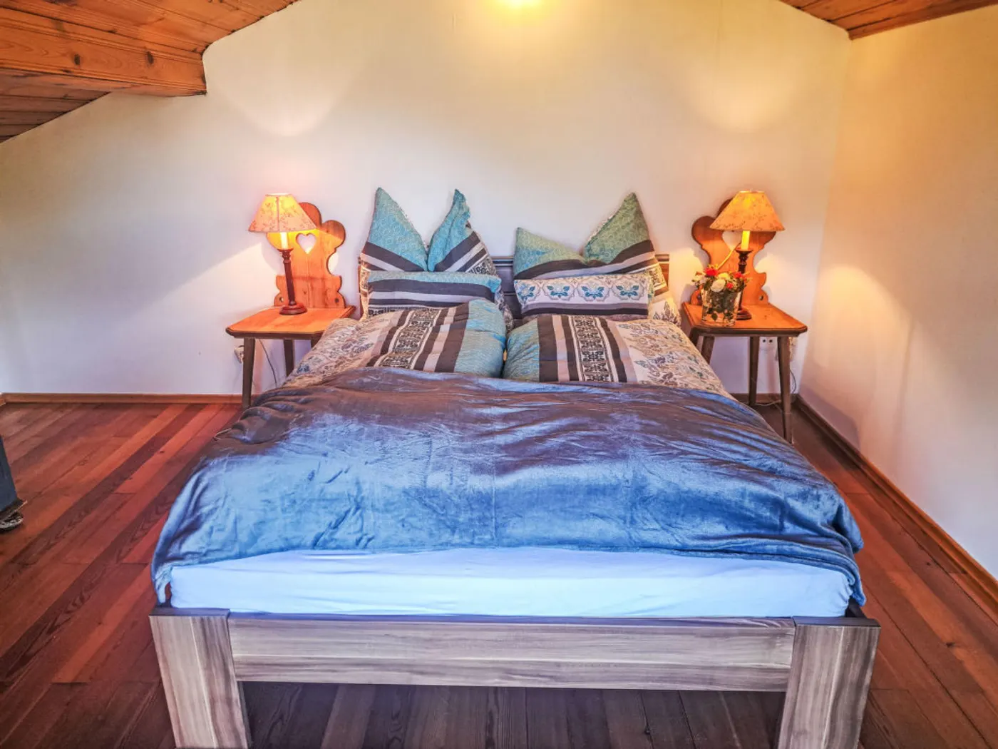 Bedroom of Villa Rose with a double bed and wooden floor
