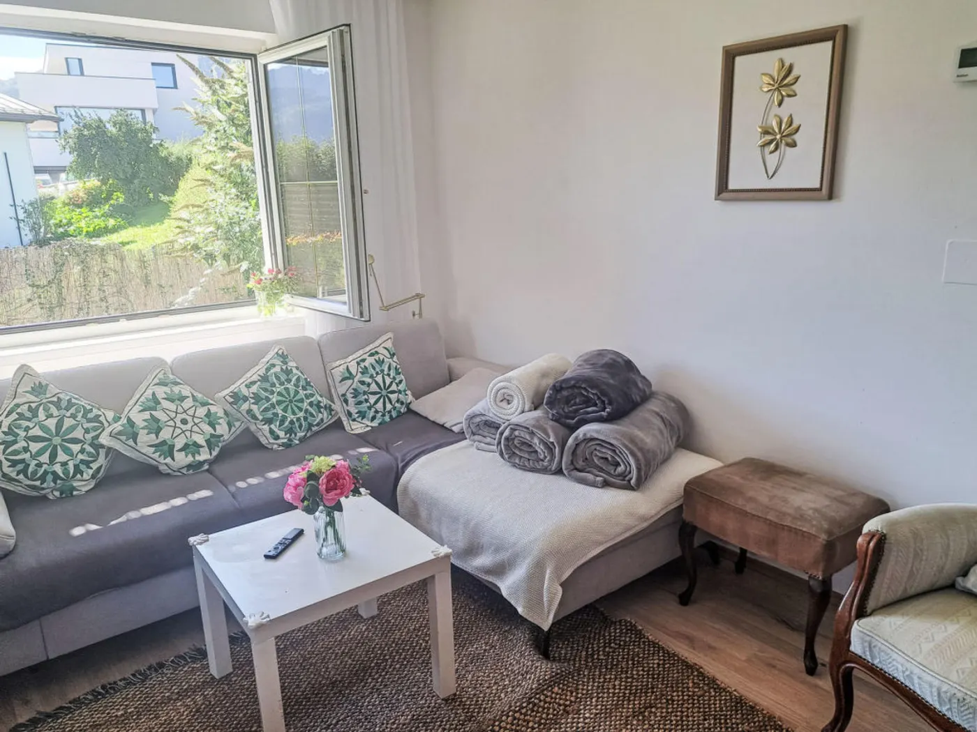 Bright living area of Villa Rose with daylight and seating by the window